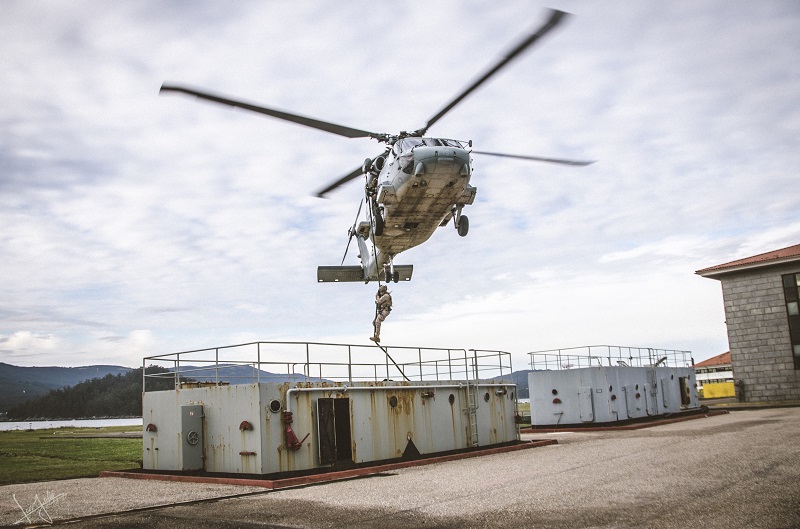 SH-60 F conducting a fast rope exercise. 