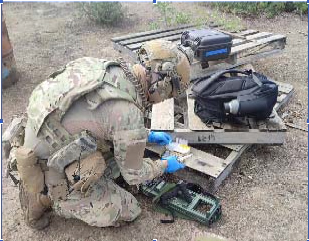 An EOD operator identifying an explosive substance.